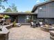 Spacious backyard featuring a brick patio with a fire pit, comfortable seating, and an outdoor dining area at 7055 E Heritage S Pl, Centennial, CO 80111