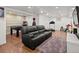 Finished basement features a spacious seating area, game area, hardwood floors, and ample room for activities at 7055 E Heritage S Pl, Centennial, CO 80111