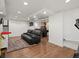 Finished basement area with recreational space, including a seating area, workout equipment, and game table at 7055 E Heritage S Pl, Centennial, CO 80111
