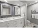 Well-lit bathroom featuring double vanity, stylish mirrors, and modern fixtures for a spa-like experience at 7055 E Heritage S Pl, Centennial, CO 80111