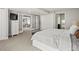 Spacious bedroom featuring plush carpet, ample closet space, and adjoining living area with glass doors at 7055 E Heritage S Pl, Centennial, CO 80111