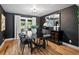 Elegant dining room features stylish black furniture and decor against dark walls with hardwood floors at 7055 E Heritage S Pl, Centennial, CO 80111