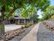 Charming home with a well-manicured front yard, beautiful landscaping, and a welcoming entrance at 7055 E Heritage S Pl, Centennial, CO 80111