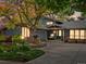 Charming single-Gathering home at twilight, featuring manicured landscaping, and exterior uplighting at 7055 E Heritage S Pl, Centennial, CO 80111