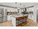 Modern kitchen with white cabinets, an island with seating, and stainless steel appliances at 7055 E Heritage S Pl, Centennial, CO 80111