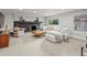 Comfortable living room boasts a fireplace, plush seating, neutral decor, and a large window for natural light at 7055 E Heritage S Pl, Centennial, CO 80111