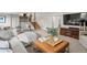 Spacious living room includes stairs and boasts ample seating, modern décor, and a large entertainment center at 7055 E Heritage S Pl, Centennial, CO 80111
