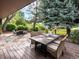 Cozy outdoor dining area boasts ample seating and a view of the landscaped backyard at 7055 E Heritage S Pl, Centennial, CO 80111
