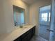 Small bathroom with single vanity and view into bedroom at 4664 Windmill Dr, Thornton, CO 80601