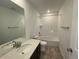 Bathroom with single vanity, tub and shower combo at 4664 Windmill Dr, Thornton, CO 80601