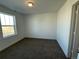 Bright bedroom with carpeted floor and large window at 4664 Windmill Dr, Thornton, CO 80601