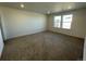 Well-lit bedroom featuring carpeted floors and neutral walls at 4664 Windmill Dr, Thornton, CO 80601