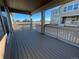 Covered deck overlooking backyard and neighboring homes at 4664 Windmill Dr, Thornton, CO 80601