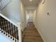 Bright entry hall with wood-look floors and modern staircase at 4664 Windmill Dr, Thornton, CO 80601