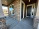 Covered front porch with stone and wood accents leading to the home's entrance at 4664 Windmill Dr, Thornton, CO 80601