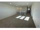 Spacious loft area with carpeted floor and multiple windows at 4664 Windmill Dr, Thornton, CO 80601