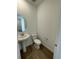 Small half bathroom with pedestal sink and a toilet at 4664 Windmill Dr, Thornton, CO 80601