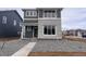 Two-story home with a stone facade, a gray accent wall, and a well-manicured gravel yard at 2261 Peregrine Dr, Brighton, CO 80601