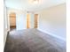 Bedroom with ensuite bathroom, neutral walls, and gray carpet at 14006 E Stanford Cir # K08, Aurora, CO 80015