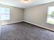 Bedroom with two windows, neutral walls, and gray carpet at 14006 E Stanford Cir # K08, Aurora, CO 80015