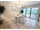 Cozy dining area featuring a four-seat table, stylish chandelier, and sliding glass doors at 14006 E Stanford Cir # K08, Aurora, CO 80015