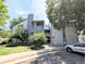 Exterior view of the modern condo building showcasing its well-maintained landscaping and convenient parking at 14006 E Stanford Cir # K08, Aurora, CO 80015