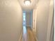 Neutral hallway featuring smooth walls and wood flooring at 14006 E Stanford Cir # K08, Aurora, CO 80015