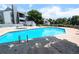 This is a beautiful view of the community pool and deck with several chairs and tables for relaxation and enjoyment at 14006 E Stanford Cir # K08, Aurora, CO 80015