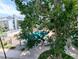 Community pool view partially obstructed by tree; a refreshing amenity for residents to enjoy at 14006 E Stanford Cir # K08, Aurora, CO 80015
