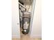 Image shows the home's modern Rheem water heater, enclosed in a utility closet with recent plumbing work at 14006 E Stanford Cir # K08, Aurora, CO 80015