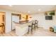 Basement bar area featuring granite countertops, barstool seating, and a convenient refrigerator at 10762 W 54Th Pl, Arvada, CO 80002