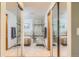 Primary bathroom with double mirrored closet, soaking tub and separate tiled shower at 10762 W 54Th Pl, Arvada, CO 80002