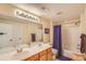 Well-lit bathroom featuring double sinks, a large mirror, and a shower-tub combination at 10762 W 54Th Pl, Arvada, CO 80002
