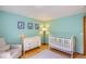 Comfortable Bedroom with wood floors, a white crib, and neutral color palette at 10762 W 54Th Pl, Arvada, CO 80002