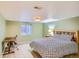 Bedroom featuring a patterned comforter, a desk, and a window with a view to the backyard at 10762 W 54Th Pl, Arvada, CO 80002