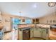 Open kitchen featuring granite countertops, stainless appliances, and backyard views at 10762 W 54Th Pl, Arvada, CO 80002