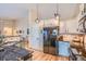 Well-lit kitchen featuring sleek appliances, granite countertops, and modern pendant lighting at 10762 W 54Th Pl, Arvada, CO 80002