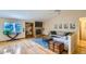 Bright and airy living room with hardwood floors, stone fireplace, and a large window at 10762 W 54Th Pl, Arvada, CO 80002
