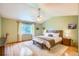 Spacious main bedroom with vaulted ceiling, bench seat and hardwood flooring at 10762 W 54Th Pl, Arvada, CO 80002
