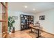 Well-lit home office featuring a large bookshelf, wooden desk, and hardwood floors at 10762 W 54Th Pl, Arvada, CO 80002