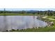 Scenic view of the community pond with walking path and mountain views at 10762 W 54Th Pl, Arvada, CO 80002