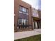 Elegant townhome featuring a brick facade, large windows, and a covered entryway, showcasing a modern architectural design at 1884 Ford St, Golden, CO 80401