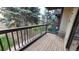 Cozy balcony with wood decking and a view of the lush green courtyard at 10890 W Evans Ave # 2E, Lakewood, CO 80227