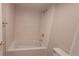 Bright bathroom featuring a shower-over-tub combination with sleek tile surround and neutral fixtures at 10890 W Evans Ave # 2E, Lakewood, CO 80227