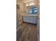 Bathroom featuring a white vanity with ample storage space and modern flooring at 10890 W Evans Ave # 2E, Lakewood, CO 80227