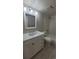 Well-lit bathroom features a white vanity, sleek fixtures, and tiled tub-shower combination at 10890 W Evans Ave # 2E, Lakewood, CO 80227