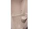 Updated bathroom featuring a tiled shower-over-tub, modern toilet, and neutral color palette at 10890 W Evans Ave # 2E, Lakewood, CO 80227