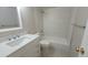 Bathroom featuring modern white tiling in the shower, complemented by a sleek vanity and neutral color palette for a serene feel at 10890 W Evans Ave # 2E, Lakewood, CO 80227