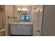 Clean bathroom with vanity, sink, and large mirror, complemented by a door for added privacy at 10890 W Evans Ave # 2E, Lakewood, CO 80227