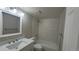 Bright bathroom features a white vanity, updated fixtures, and tiled tub-shower combination at 10890 W Evans Ave # 2E, Lakewood, CO 80227